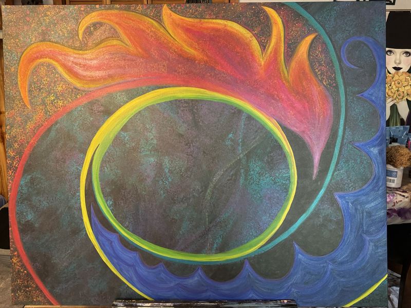 Early stage of a large painting with a rainbow ring, orange and pink flames and blue waves around a dark empty circle