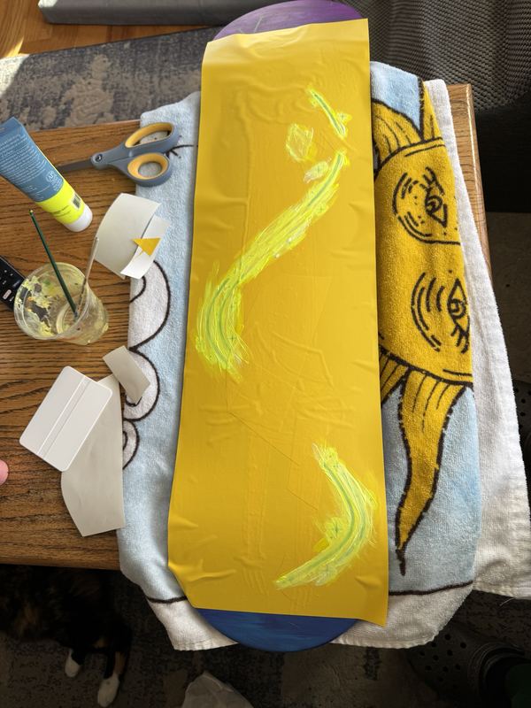 Yellow vinyl mask with neon swooshes painted around it